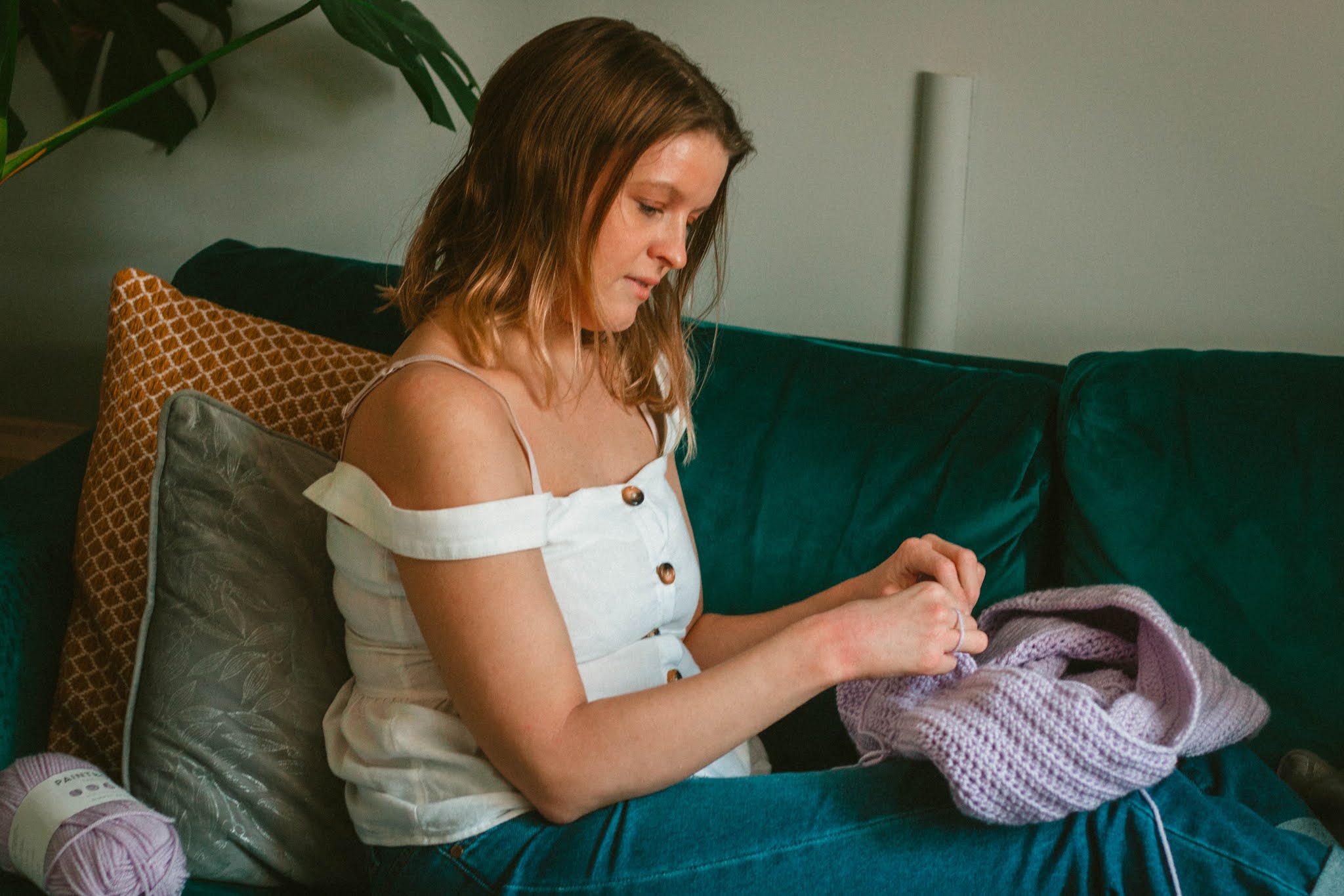 girl crocheting lilac jumper - 5 creative hobbies for self care blog post