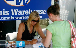 Photo of Maria Sharapova signing autographs for her fans