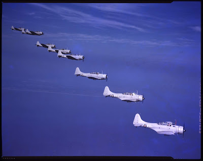 Seven aircraft flying in left echelon formation