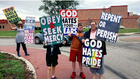 Westboro Baptist Church members demonstrate outside of Olathe North High School on May 20, 2018, near Kansas City. Nearly all WBC signs now contain biblical references. Photo courtesy of WBC