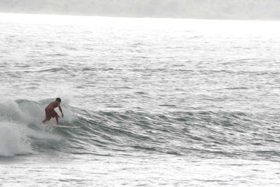 Surfing on the Tanjung Setia Beach, West Lampung, Indonesia