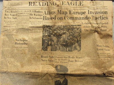 Yellowed and crinkled front page of Aug. 20, 1942, Reading Eagle, reporting various stories of World War II