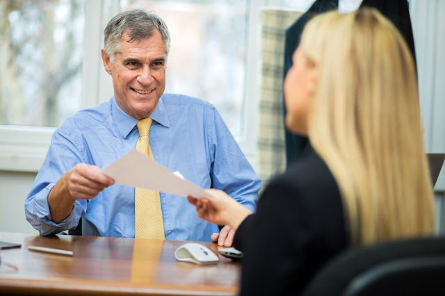 Image of a smiling bank manager with customer