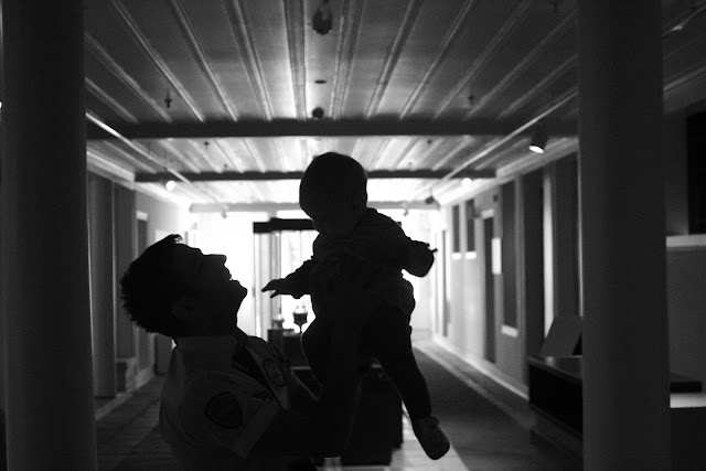 Neve being held by the security guard in the museum.