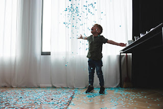 Image of Boy Throwing Confetti