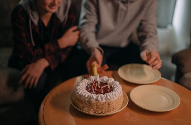 man and woman eating cake