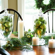 fruit and tall vases with candles and greenery Christmas table