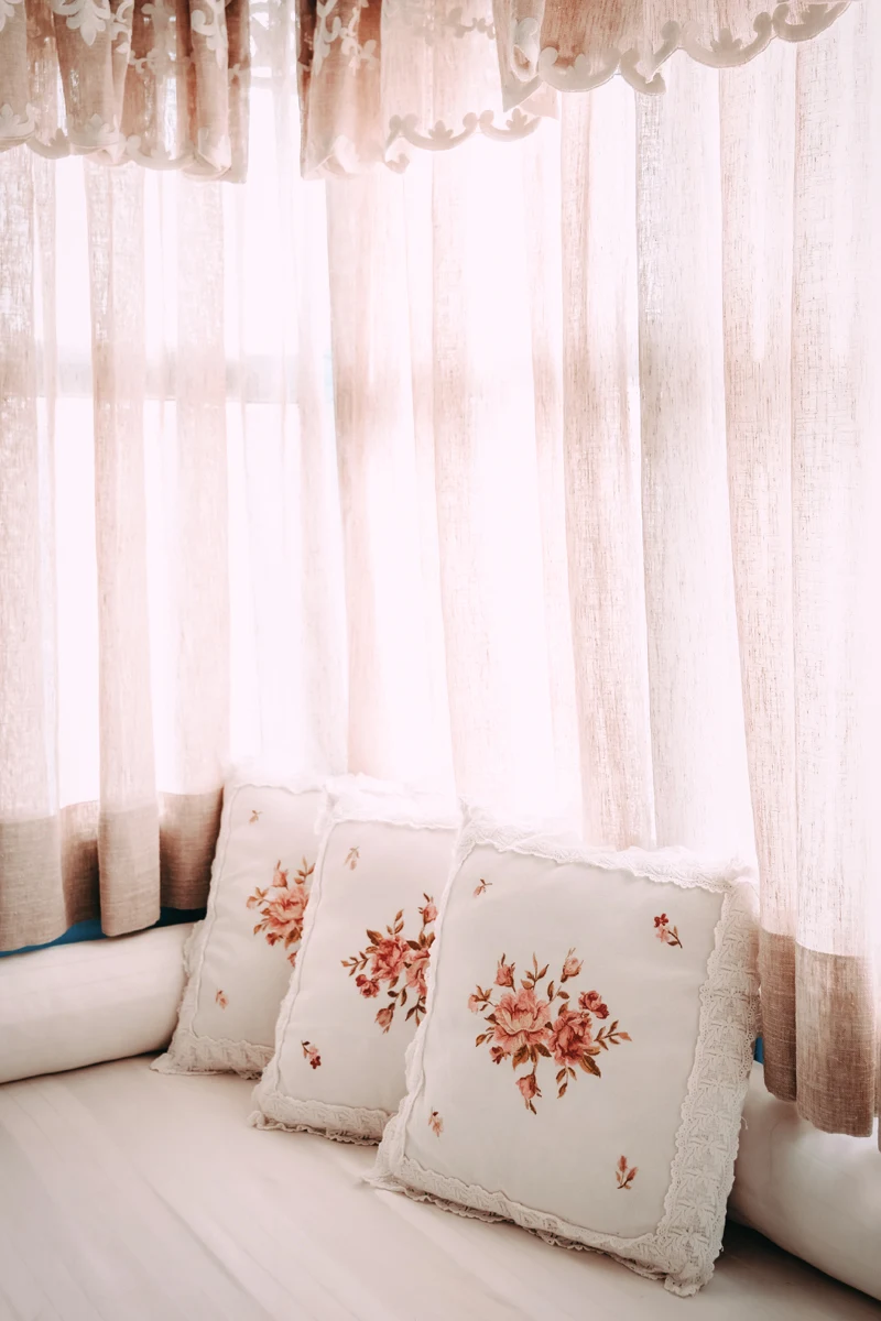 light , floral bohemian curtains on a window