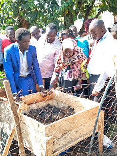 Mr Odur Emmanuel with one of the earth worm farmers  explaining earth worm generating breeding process