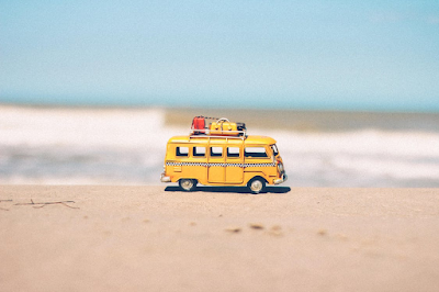 A mini yellow van on the beach