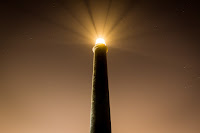 Lighthouse in Night - Photo by Pablo Orcaray on Unsplash