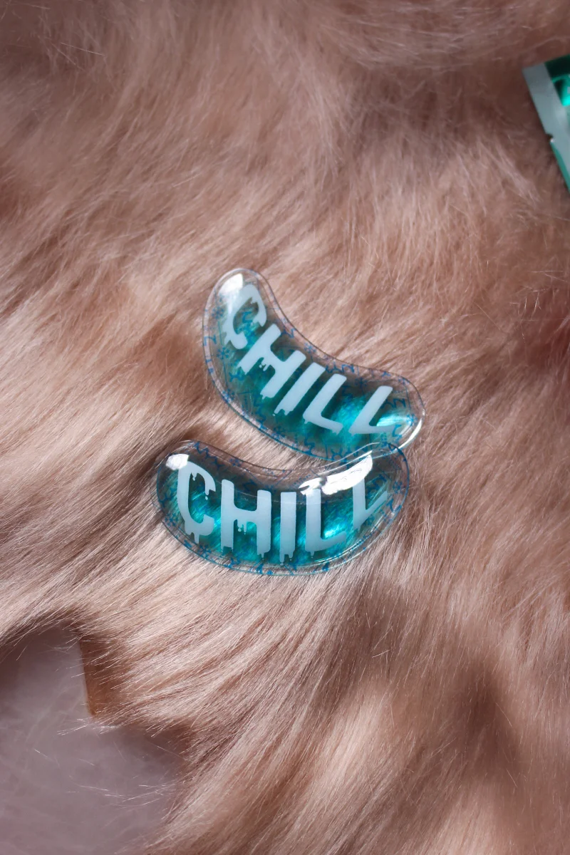 close-up shot of two silicone under eye patches on top of rose gold rug