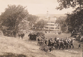 A parade of figures moving through campus.