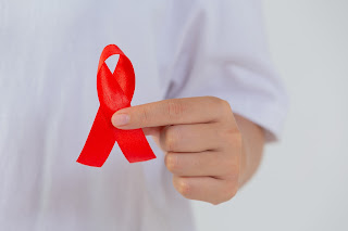 Women Holding Red Cancer Ribbon - Best Radiation Oncologist in Delhi ncr