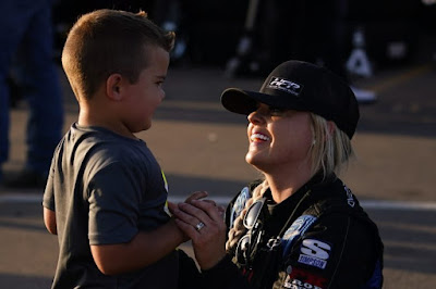 Jessica Friesen plays with her son before the race.