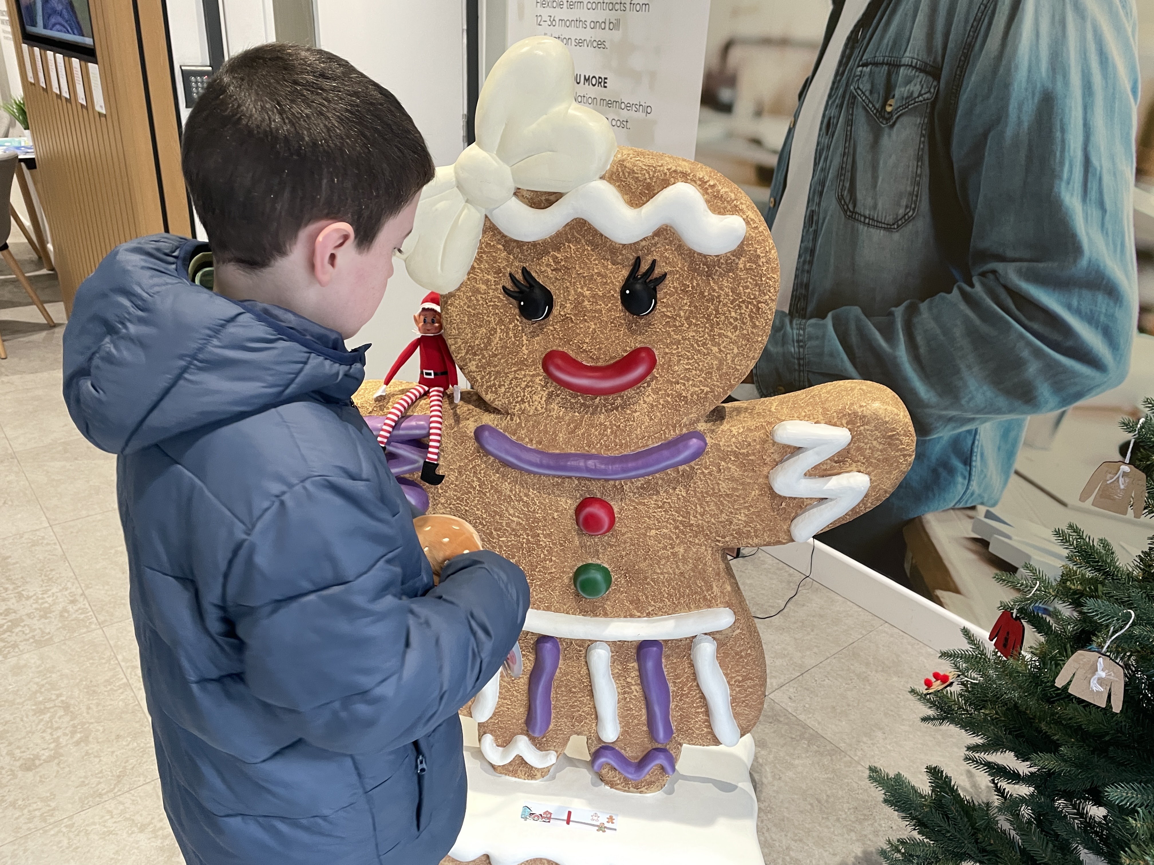 boy looking at a gingerbread character