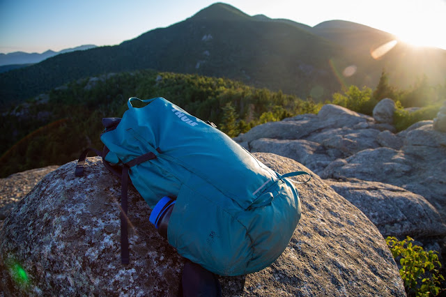 Backpack perched on a rock