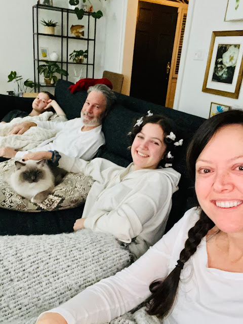 four people and a cat on the sofa