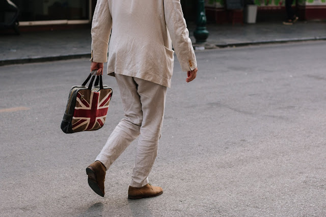  man with Union Jack flag bag Photo by quan le on Unsplash