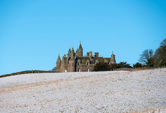 Balintore castle peeking over the snowy hillside