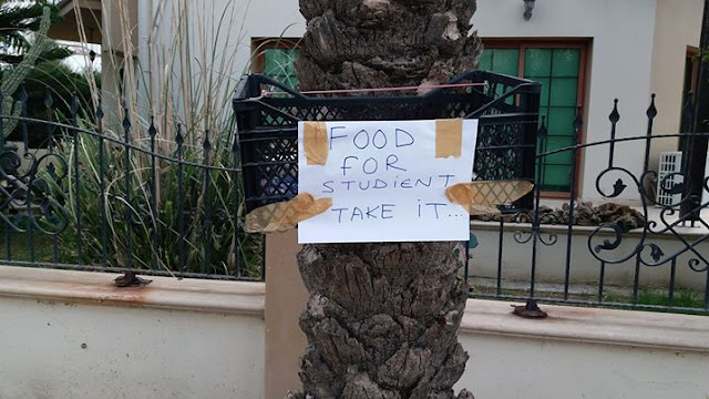 Turkish Cypriot hangs food basket on a tree outside his house for students
