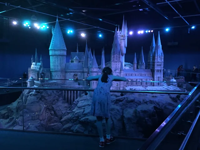 sasha overlooking giant hogwarts model