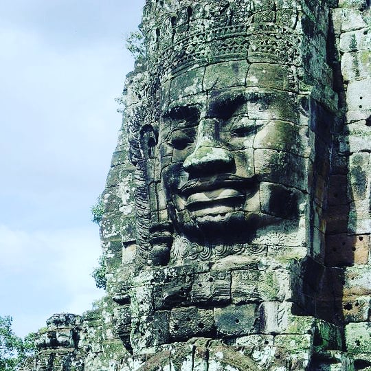 smiling buddha face of canyon temple cambodia