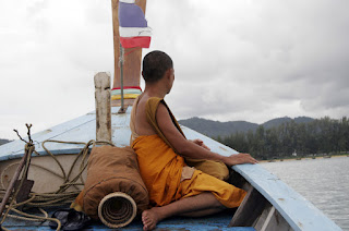 Monk on longtail boat heading back to Rawai beach