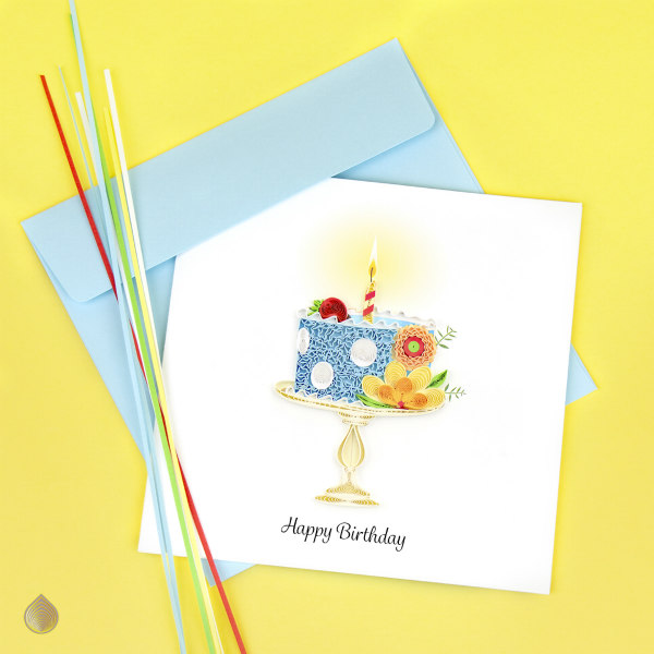 quilled birthday cake card alongside several quilling strips