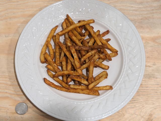 A plate of Checkers / Rally's frozen Famous Seasoned Fries out of the air fryer.