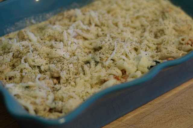 The Cheese added to the top of the Easy Tuscan Chicken Pasta in the baking dish. 