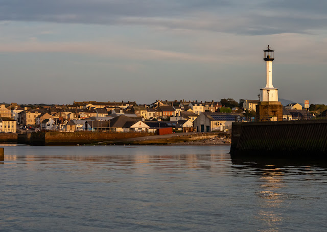 Photo ofo Maryport Lighthouse and the town in the evening sunshine