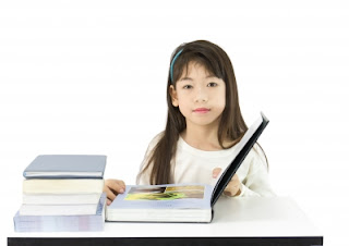 Young Girl Reading Book Stock Photo