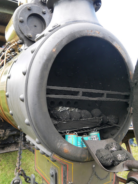 Taking baked potatoes out of a steam engine