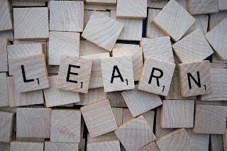 blank scrabble tiles with the word LEARN spelled out