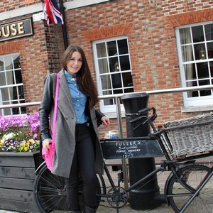 boylish coat and neon satchel