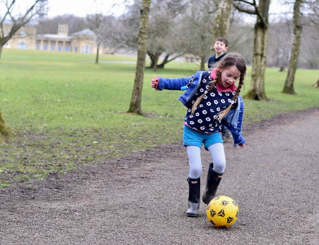 girl playing football in Heaton Park, Manchester