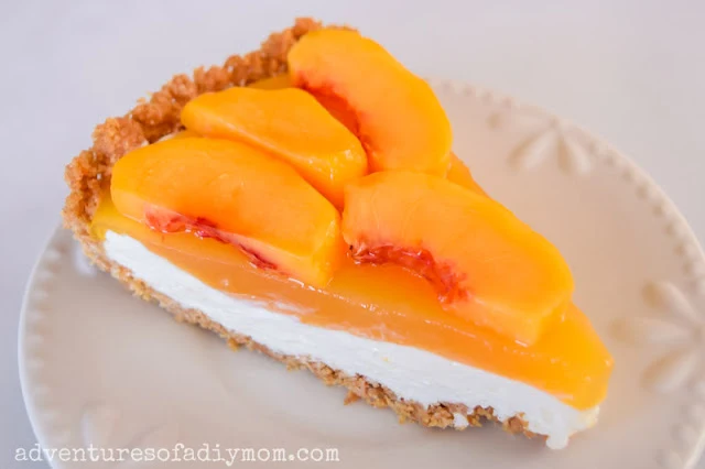 peach pie with a graham cracker crust, creamy filling and peachy top layer