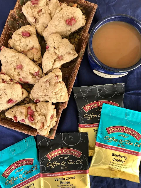 Whole wheat cardamom rhubarb scones surrounded by coffee packets.