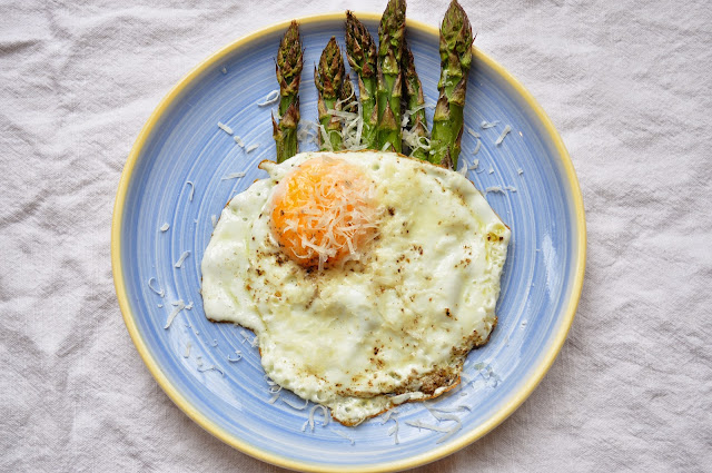 Asparagus with a fried egg and parmesan.