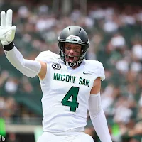 John Cockslam, dressed in a foam finger and a grin, celebrates his unique touchdown during a Michigan State football game.