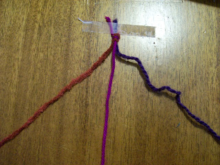 Three colored strands of yarn.