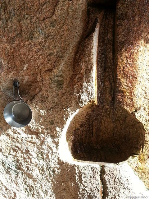 Natural spring water trickling down the side of the cave.