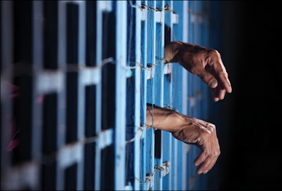 Hand inside prison bars
