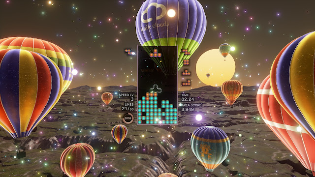 Screenshot of a level with hot air balloons in Tetris Effect: Connected