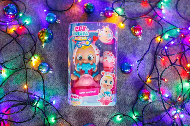 A Cry Babies Magic Tears Stars: Jumpy Monsters doll featuring Momo in the packaging surrounded by fairy lights