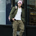 Brooklyn Beckham teams camouflage gear with a bold pink hat