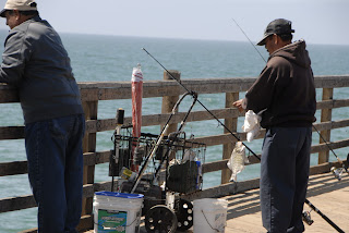 men fishing along the pier