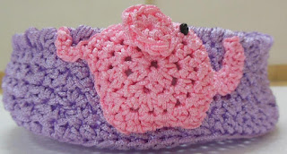 Sweet Nothings Crochet free crochet pattern blog, photo of the next purple medium nesting basket with a pink elephant motif on one side