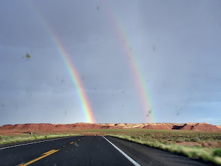 A double rainbow through a bug-splattered windshield near Cameron, AZ